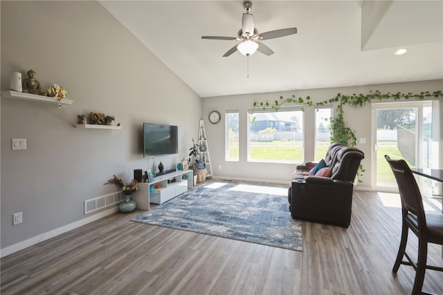 living room featuring high vaulted ceiling, wood-type flooring, ceiling fan, and plenty of natural light