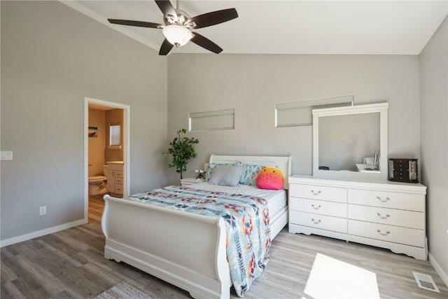 bedroom featuring ceiling fan, vaulted ceiling, light hardwood / wood-style floors, and ensuite bathroom