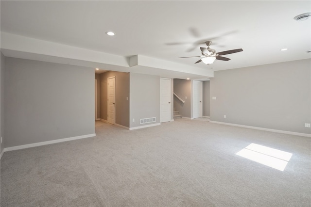 carpeted spare room featuring ceiling fan