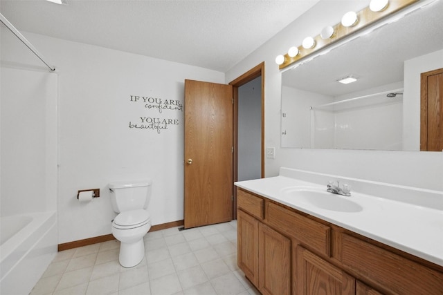 full bathroom with  shower combination, vanity, toilet, and a textured ceiling