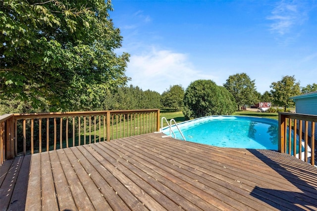 view of swimming pool featuring a wooden deck