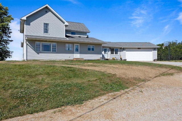 view of front of home with a front yard and a garage