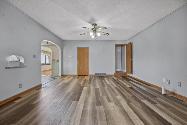 spare room with wood-type flooring, ceiling fan, and a textured ceiling