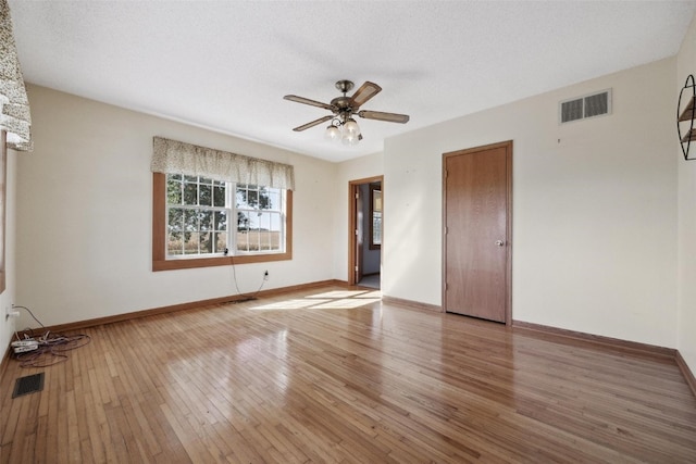 spare room featuring a textured ceiling, ceiling fan, and hardwood / wood-style flooring