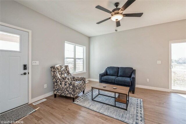 sitting room with ceiling fan and light hardwood / wood-style floors