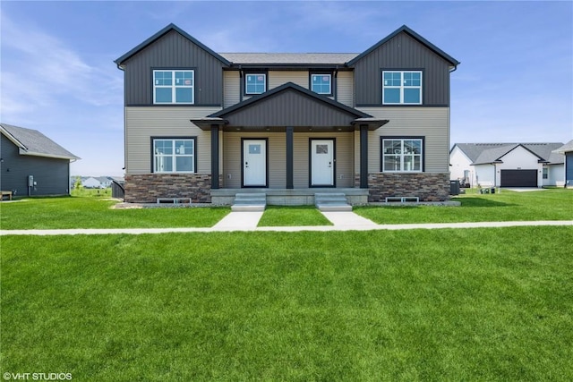 2390 Bluegrass St, Marion, IA 52302 - view of front facade featuring board and batten siding, stone siding, covered porch, and a front yard
