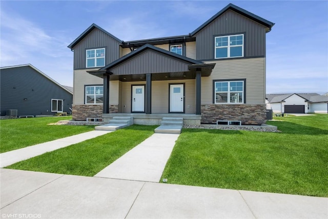 2390 Bluegrass St, Marion, IA 52302 - view of front facade featuring stone siding, board and batten siding, a porch, and a front yard