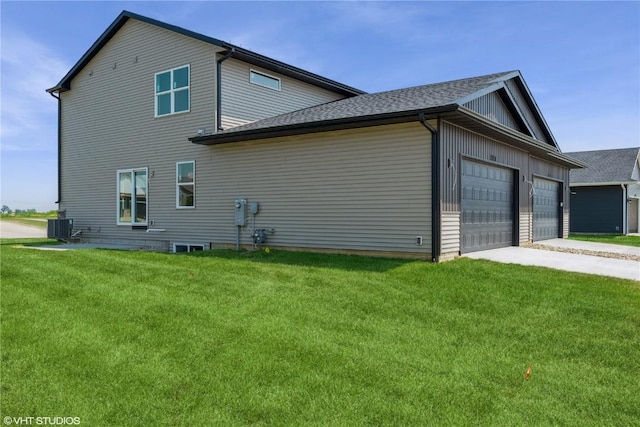 2390 Bluegrass St, Marion, IA 52302 - view of side of property with a lawn, driveway, a garage, and roof with shingles