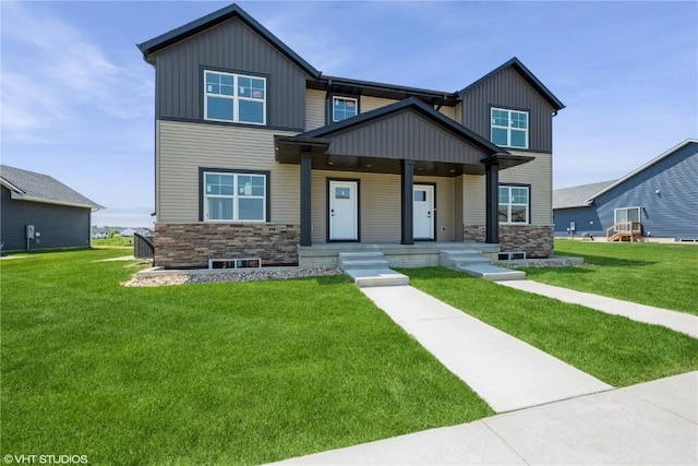 2390 Bluegrass St, Marion, IA 52302 - craftsman-style house featuring stone siding, covered porch, a front yard, and board and batten siding