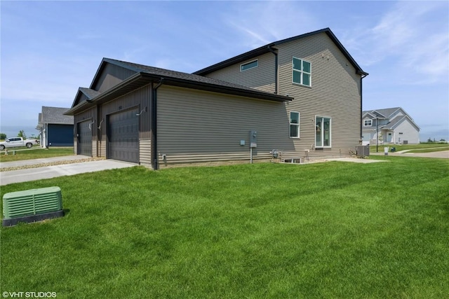 2398 Bluegrass St, Marion, IA 52302 - view of side of property with a lawn, driveway, and an attached garage