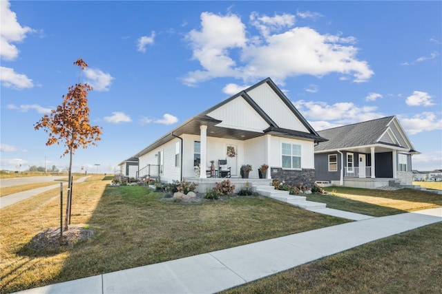 craftsman-style house with a front yard and covered porch