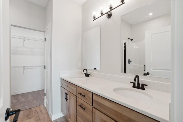 bathroom with vanity, wood-type flooring, and a shower