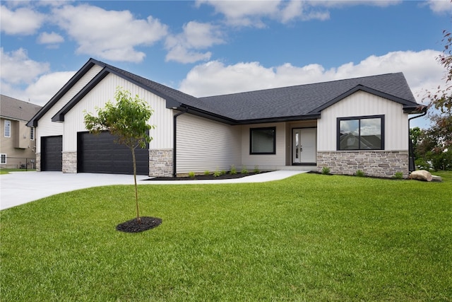 view of front of home with a front yard and a garage