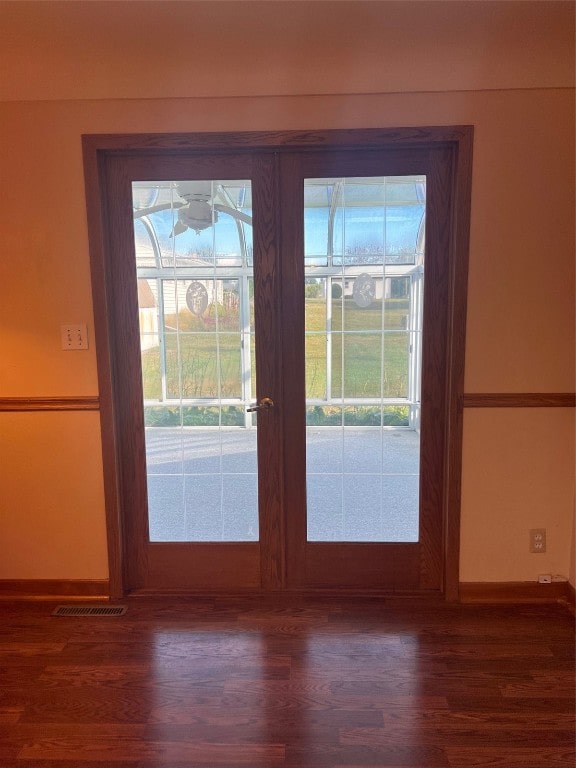 entryway featuring dark hardwood / wood-style floors and french doors