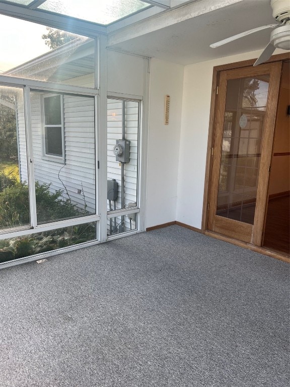 unfurnished sunroom featuring ceiling fan