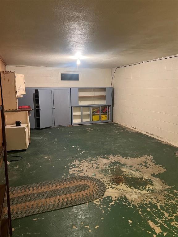 419 W 15th St, Vinton, IA 52349 - below grade area featuring a textured ceiling and concrete block wall