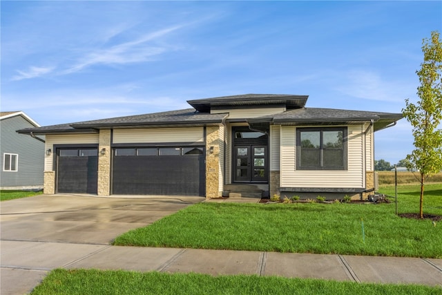 prairie-style house with a front yard and a garage