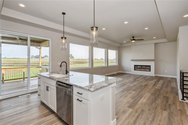 kitchen featuring pendant lighting, sink, white cabinets, ceiling fan, and stainless steel dishwasher