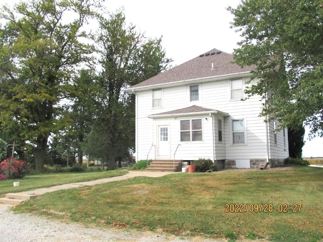 rear view of property with a lawn