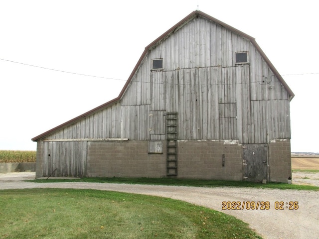 view of property exterior featuring a yard and an outbuilding