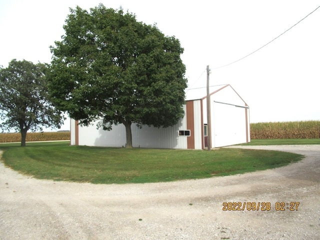 view of outbuilding with a lawn