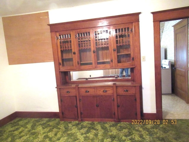 kitchen featuring light carpet and washer / clothes dryer