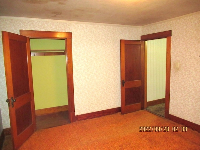 carpeted spare room featuring ornamental molding