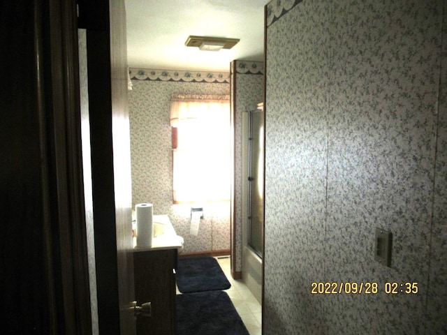 bathroom with vanity, a textured ceiling, tile patterned flooring, and an enclosed shower