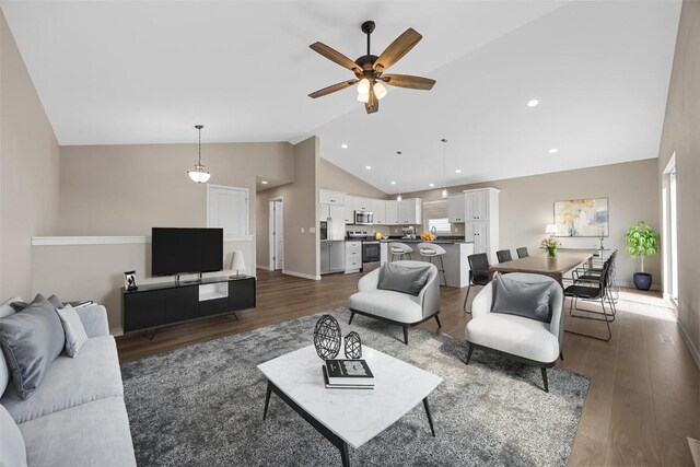 living room featuring high vaulted ceiling, ceiling fan, and dark hardwood / wood-style floors