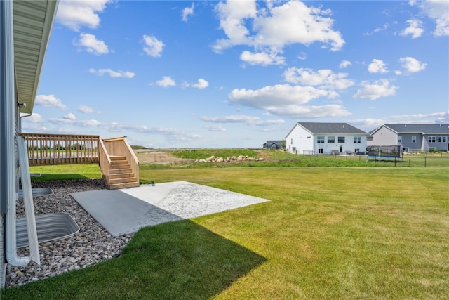 view of yard with a patio and a trampoline