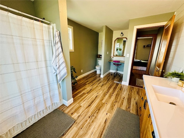 bathroom featuring vanity, hardwood / wood-style floors, and toilet