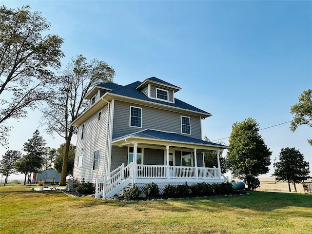 view of front facade with a front lawn and a porch