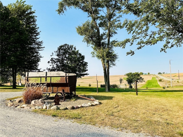 surrounding community featuring a lawn and a rural view