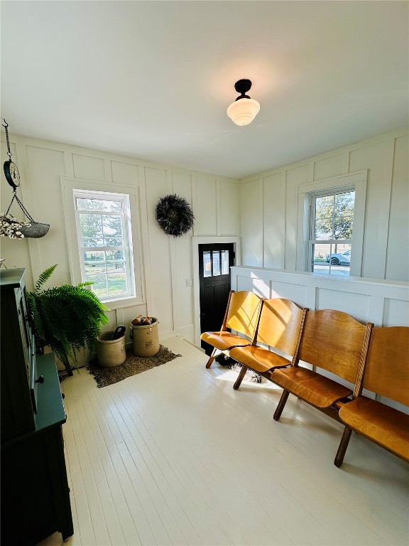 sitting room featuring a wealth of natural light and hardwood / wood-style floors