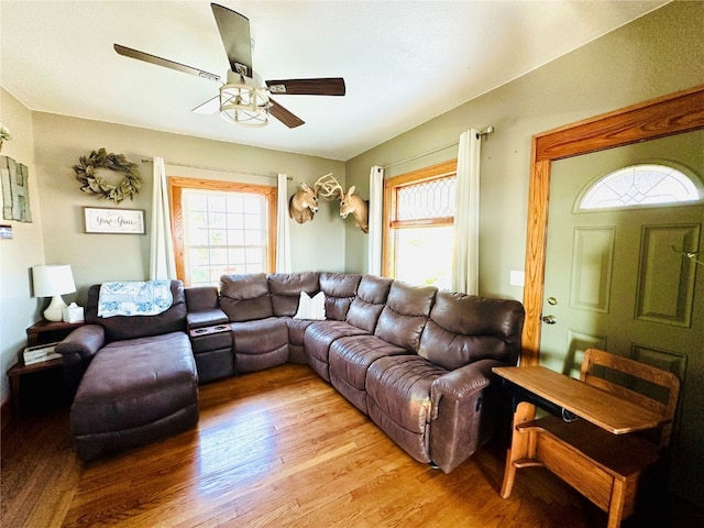 living room featuring light hardwood / wood-style flooring and ceiling fan