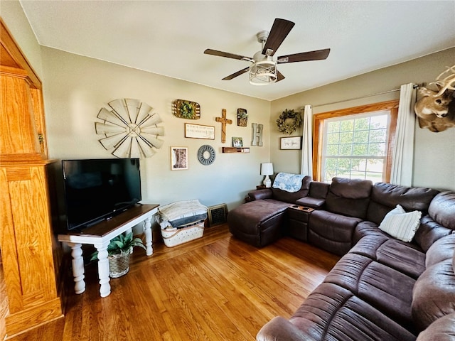 living room with hardwood / wood-style floors and ceiling fan