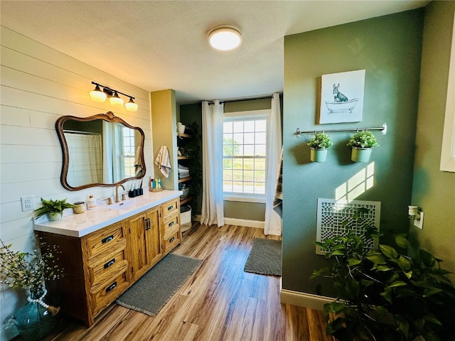 bathroom with vanity, hardwood / wood-style floors, a textured ceiling, and toilet