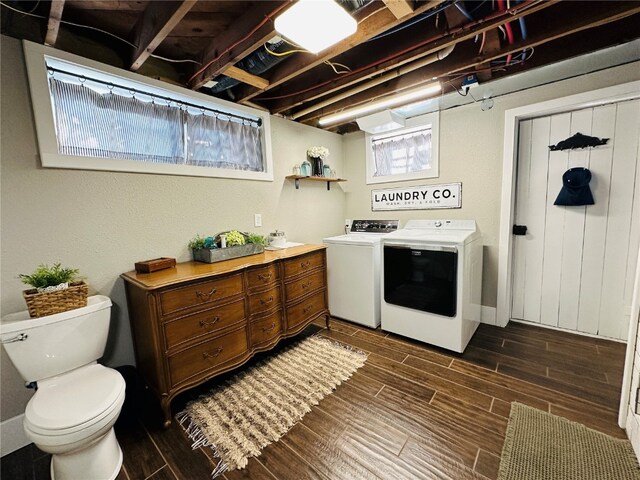 laundry area with washer and dryer and dark hardwood / wood-style floors