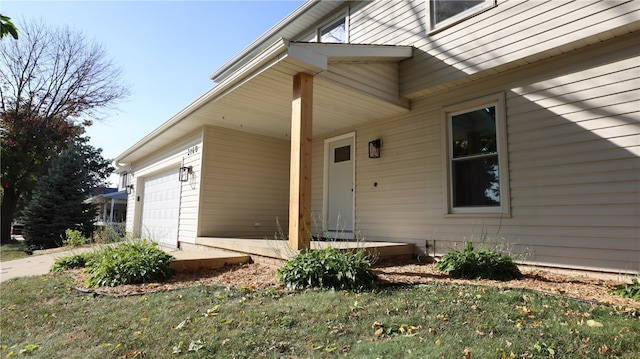 view of exterior entry with a garage