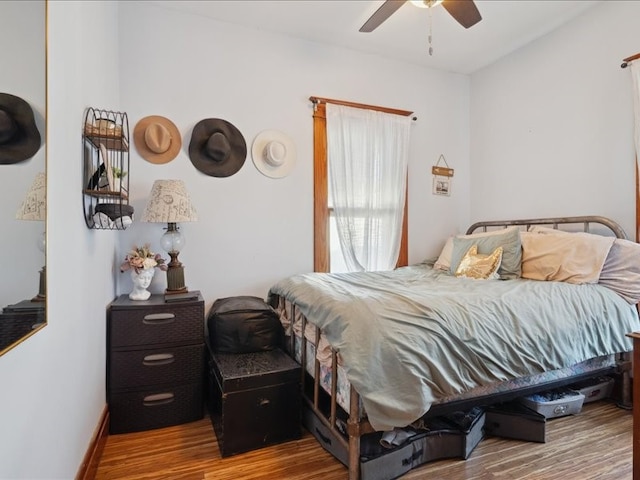 bedroom with ceiling fan and wood-type flooring