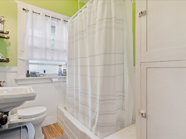 bathroom with shower / tub combo and toilet