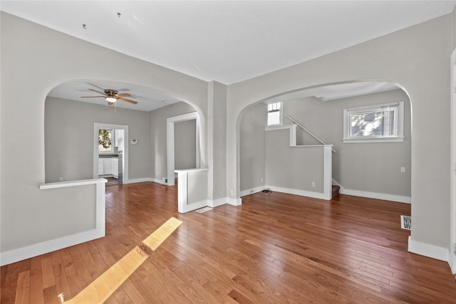 empty room with hardwood / wood-style floors and ceiling fan