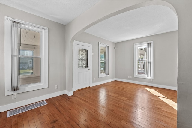 entrance foyer featuring a textured ceiling and hardwood / wood-style flooring