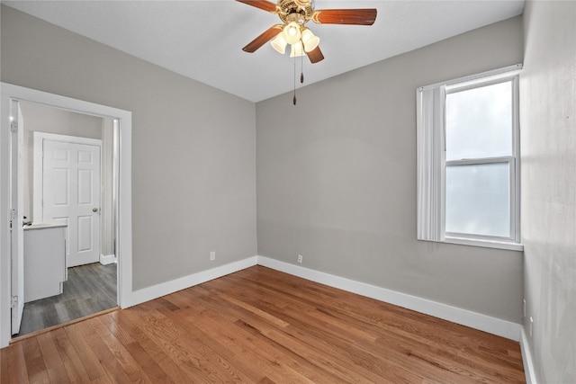 empty room featuring ceiling fan and hardwood / wood-style flooring