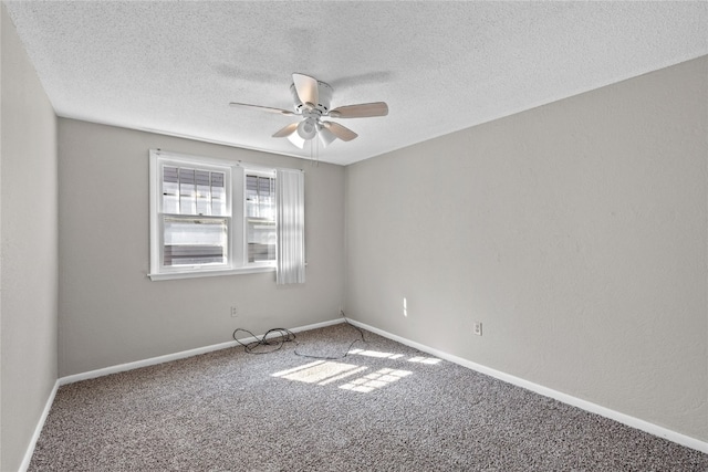 carpeted spare room featuring a textured ceiling and ceiling fan