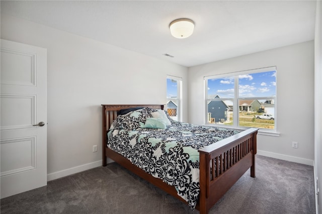 bedroom with dark carpet