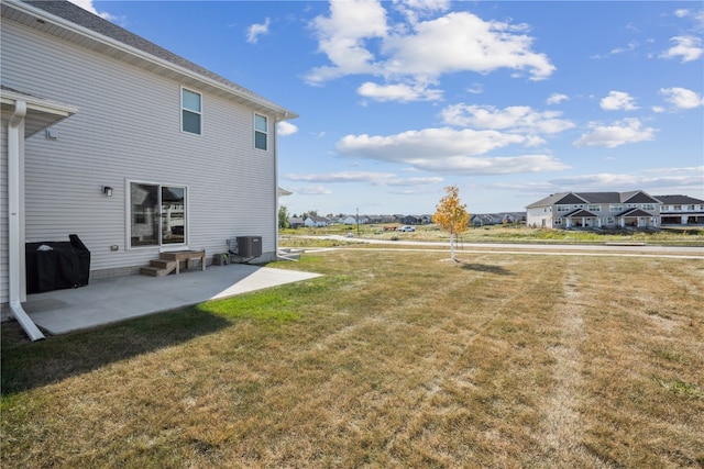 view of yard with central AC unit and a patio area