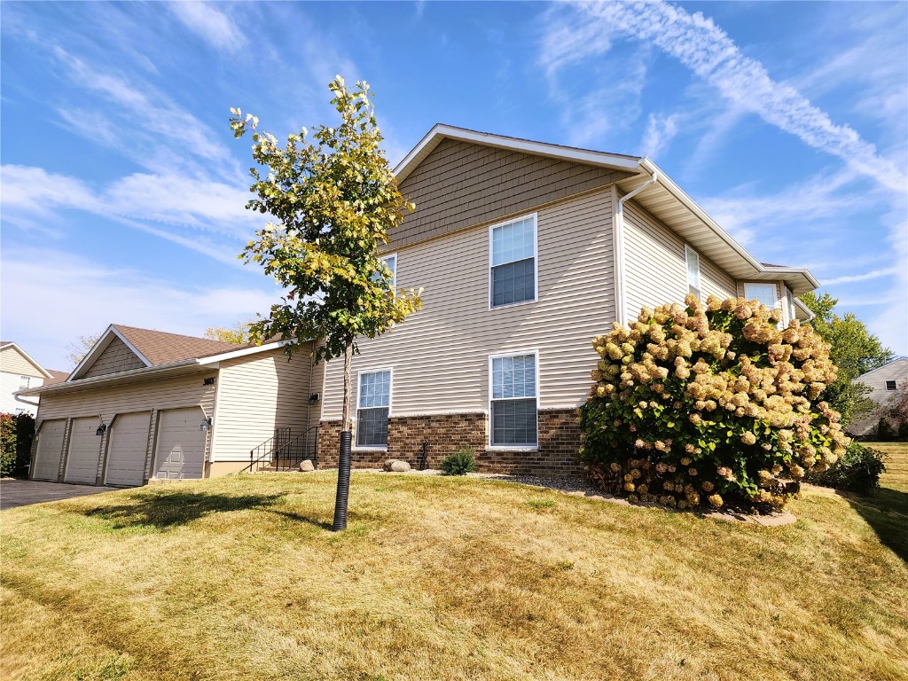 front of property with a garage and a front lawn