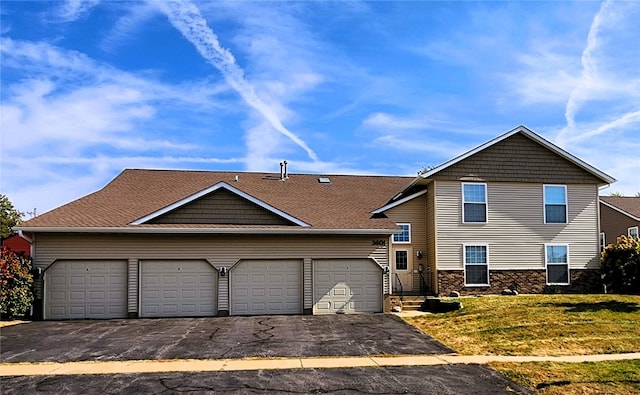 view of front facade with a garage and a front yard