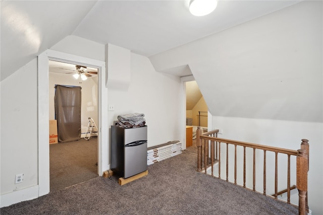 bonus room featuring dark carpet, lofted ceiling, and ceiling fan